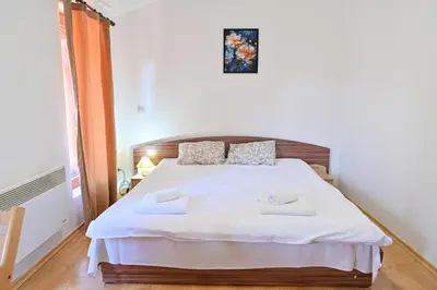 a bedroom with a white bed with two towels on it at Charming Studio with Mountain View - Bansko by Flat Mаnаger in Bansko