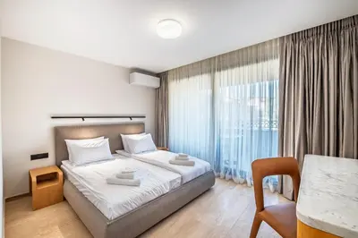 a bedroom with a bed and a large window at Nik Palas Luxury Residence in Sandanski