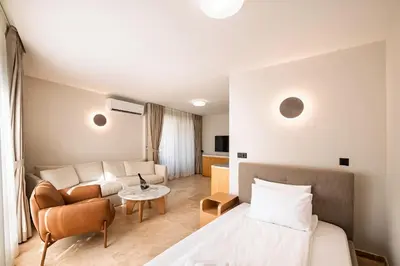 a hotel room with a bed and a couch at Nik Palas Luxury Residence in Sandanski