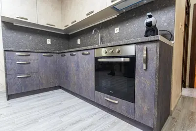 a kitchen with a stainless steel oven and cabinets at Комплекс Родопска среща - Къщи и Апартаменти in Batak