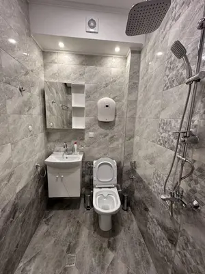 a bathroom with a toilet and a sink at Къща за гости Elion House in Hisarya