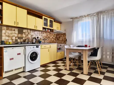 a kitchen with a washing machine and a table at AlHana Panoramic Studio - Top Center, Blagoevgrad in Blagoevgrad