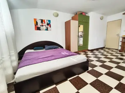 a bedroom with a bed and a checkered floor at AlHana Panoramic Studio - Top Center, Blagoevgrad in Blagoevgrad
