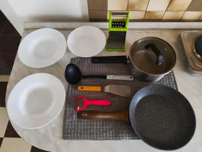 a table with white plates and utensils on it at AlHana Panoramic Studio - Top Center, Blagoevgrad in Blagoevgrad