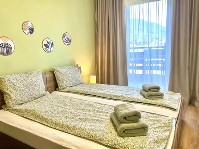 a bedroom with a bed with towels on it at Mountain Escape in Green Life Bansko by SI Stay in Bansko