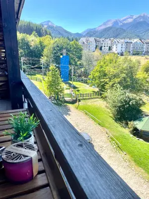 a balcony with a view of a yard and mountains at Mountain Escape in Green Life Bansko by SI Stay in Bansko