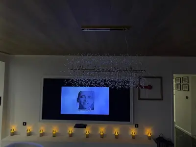 a flat screen tv in a living room with candles at Grand Trio Apartment in Plovdiv