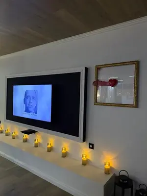 a living room with candles and a flat screen tv at Grand Trio Apartment in Plovdiv