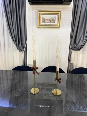 a table with two candles on top of it at Grand Trio Apartment in Plovdiv