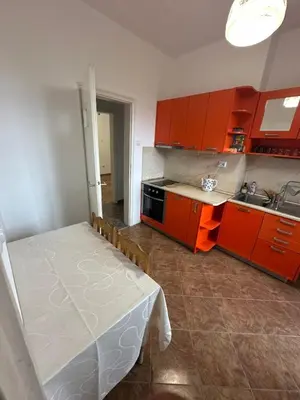 a kitchen with orange cabinets and a bed in it at Апартамент 36 in Sofia