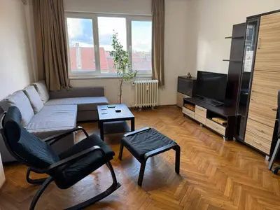 a living room with a couch and a tv at Апартамент 36 in Sofia