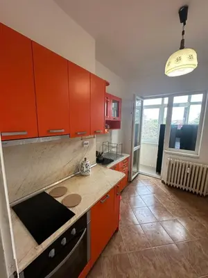 a kitchen with orange cabinets and a counter top at Апартамент 36 in Sofia
