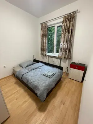 a bedroom with a bed and a window at Emlex Stylish Apartment in the Heart of Sofia in Sofia