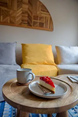 a piece of cake on a table with a cup of coffee at Luxury and stylish apartment in the heart of the city in Sofia