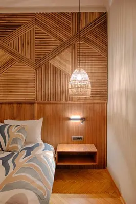 a bedroom with a bed and a wooden wall at Luxury and stylish apartment in the heart of the city in Sofia
