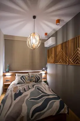a bedroom with a bed and a chandelier at Luxury and stylish apartment in the heart of the city in Sofia