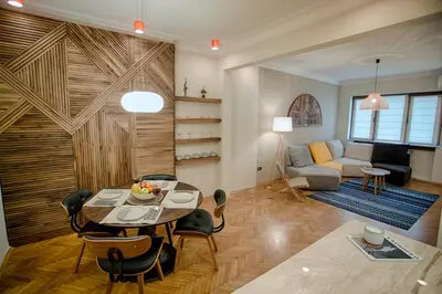 a living room with a table and a couch at Luxury and stylish apartment in the heart of the city in Sofia