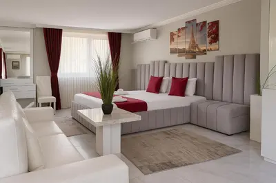 a hotel room with a bed and a couch at Парк Апарт-Хотел Виктория 1 in Sandanski