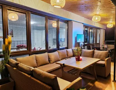 a living room with a couch and a table at Парк Апарт-Хотел Виктория 1 in Sandanski