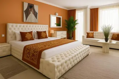 a bedroom with a large white bed and a couch at Парк Апарт-Хотел Виктория 1 in Sandanski