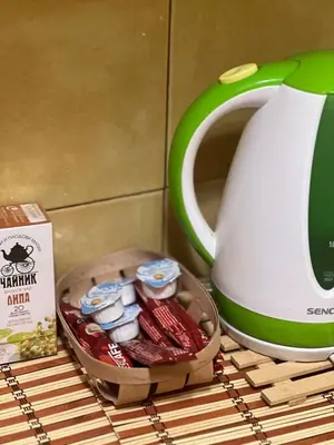 a basket of food next to a tea kettle at Cozy apartment with balcony and panoramic view in Sofia