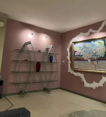 a room with a shelf and a painting on the wall at Cozy apartment with balcony and panoramic view in Sofia