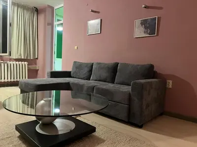 a living room with a couch and a glass table at Cozy apartment with balcony and panoramic view in Sofia