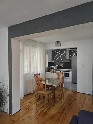 a kitchen and dining room with a table and chairs at Слънчев апартамент 44 ет 3 in Sandanski