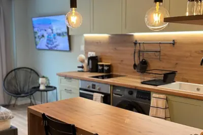 a kitchen with a stove and a sink and a table at Urban Hive - Central Designer Studio in Lozenets in Sofia