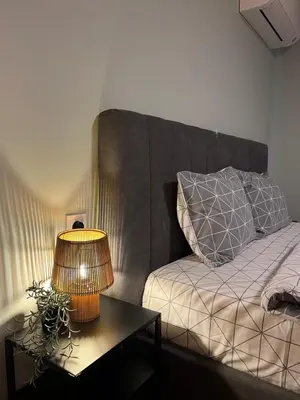 a bedroom with a bed with a lamp on a table at Urban Hive - Central Designer Studio in Lozenets in Sofia