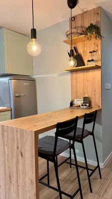 a kitchen with a wooden table and two chairs at Urban Hive - Central Designer Studio in Lozenets in Sofia