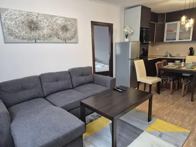 a living room with a couch and a table at 1А1 Apartament in Pamporovo