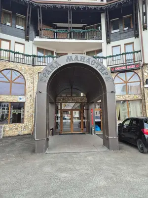 an entrance to a building with a car parked in front at 1А1 Apartament in Pamporovo