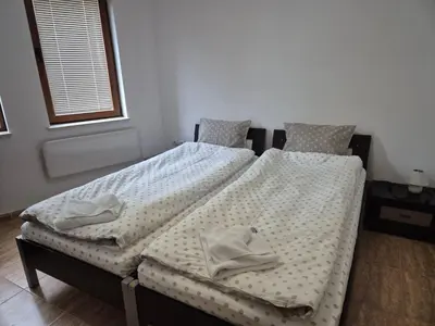 two twin beds sitting next to each other in a bedroom at 1А1 Apartament in Pamporovo