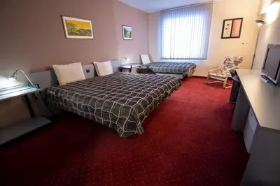 a hotel room with a bed and a couch at ATM Hotel in Sofia