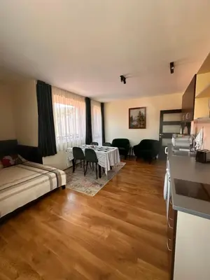 a room with a bed and a table and chairs at Private large apartment in Iglika 2 for 4 people in Borovets