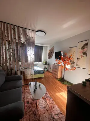 a living room with a couch and a table at Apartment near the ski lift with a private parking in Bansko