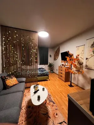 a living room with a couch and a table at Apartment near the ski lift with a private parking in Bansko