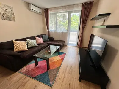 a living room with a couch and a glass table at Winslow Highland escape apartment in Bansko