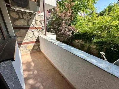 a balcony of a house with a stone wall at Winslow Highland escape apartment in Bansko