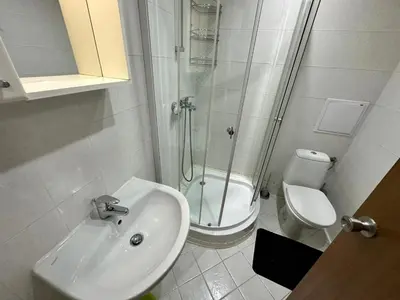 a bathroom with a shower and a sink and a toilet at Winslow Highland escape apartment in Bansko