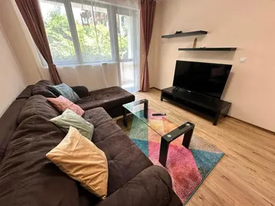 a living room with a couch and a television at Winslow Highland escape apartment in Bansko