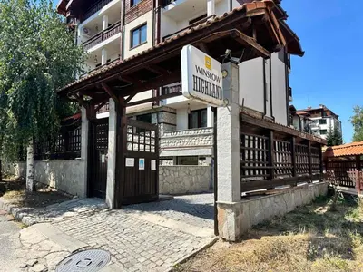 a building with a sign in front of it at Winslow Highland escape apartment in Bansko