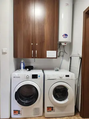 a kitchen with two washing machines and a cabinet at Mountain Dream apartment near ski road in Bansko