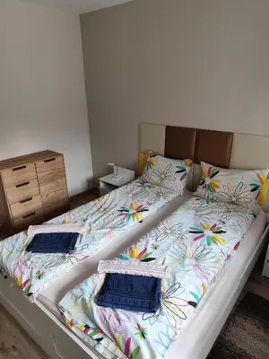 a bed with a colorful blanket and pillows on it at Apartment E45 in Borovets Gardens, Borovets resort in Borovets