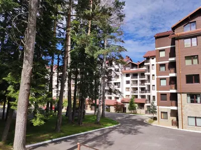 an apartment complex with trees and a street at Apartment E45 in Borovets Gardens, Borovets resort in Borovets