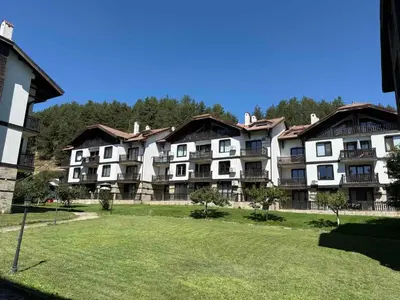 a group of apartment buildings with a grass field at ТРИ ПЛАНИНИ ап113 in Razlog