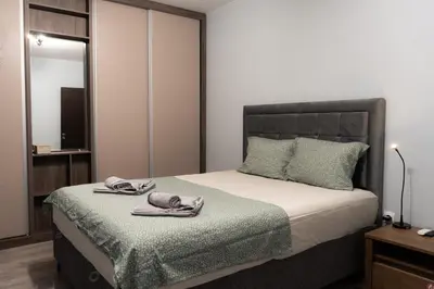a bedroom with a bed with towels on it at All Seasons Plovdiv - Fast Wi-Fi, AC, Balconies in Plovdiv