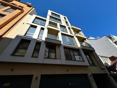 a tall building with windows on the side of it at All Seasons Plovdiv - Fast Wi-Fi, AC, Balconies in Plovdiv