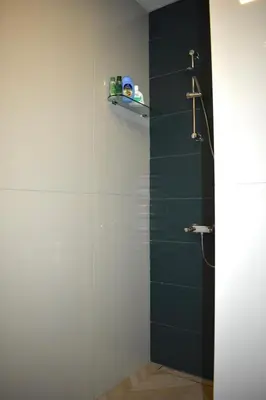 a bathroom with a shower with a glass door at The Corner apartments in Sofia